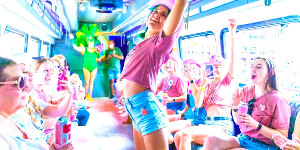 a woman dances down the runway of the big drag bus during her bachelorette party in nashville
