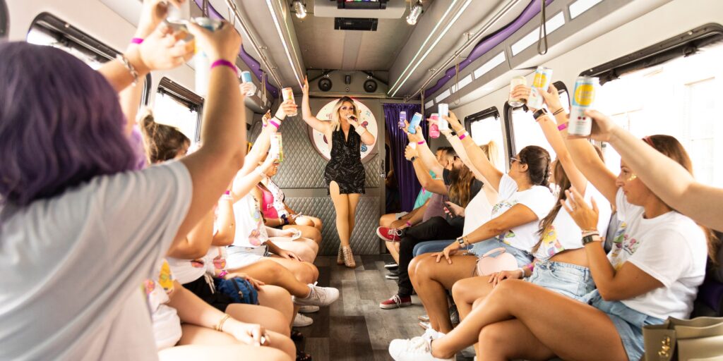 a drag queen sings while people cheer her on