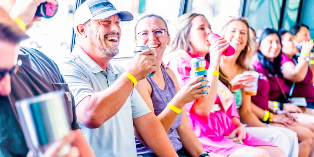 people smiling and laughing while on a party bus tour in nashville