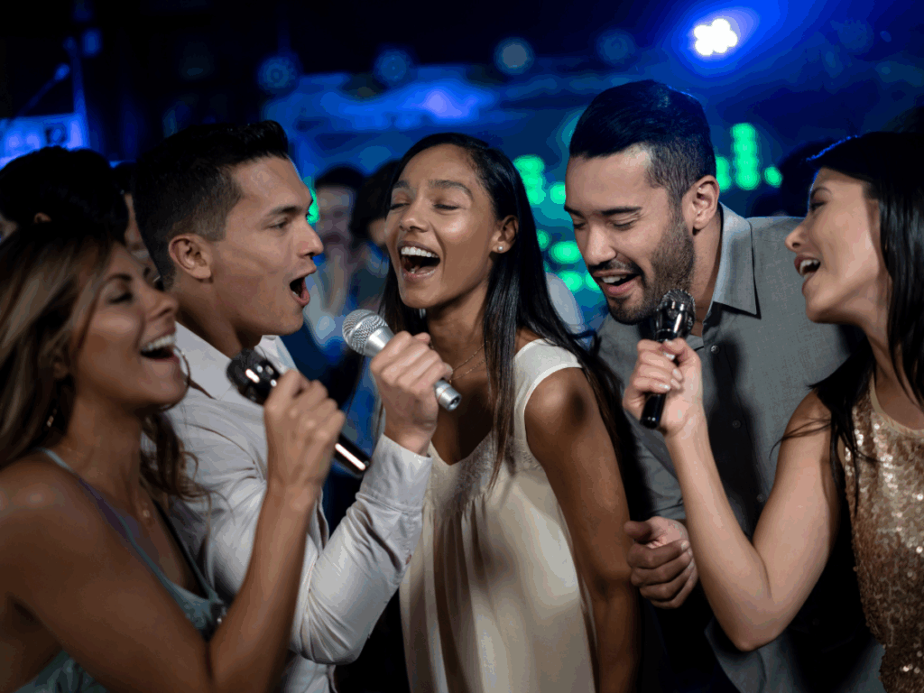 a group of people sing during karaoke as part of a group activity in nashville